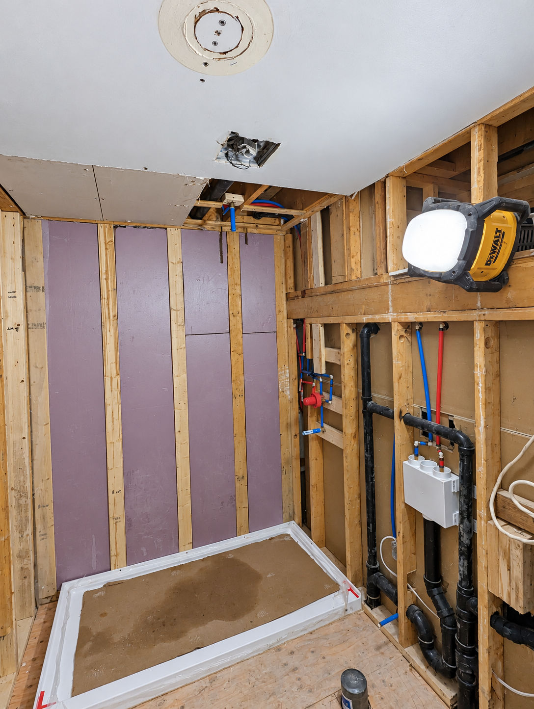 Salle de bain pendant les travaux, ossature et réseaux visibles — Austin.
